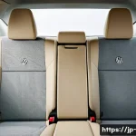 폭스바겐 파사트의 내부 공간 리뷰 - Interior view of a spacious Volkswagen Passat cabin focusing on the rear seats, showing an adult mal...